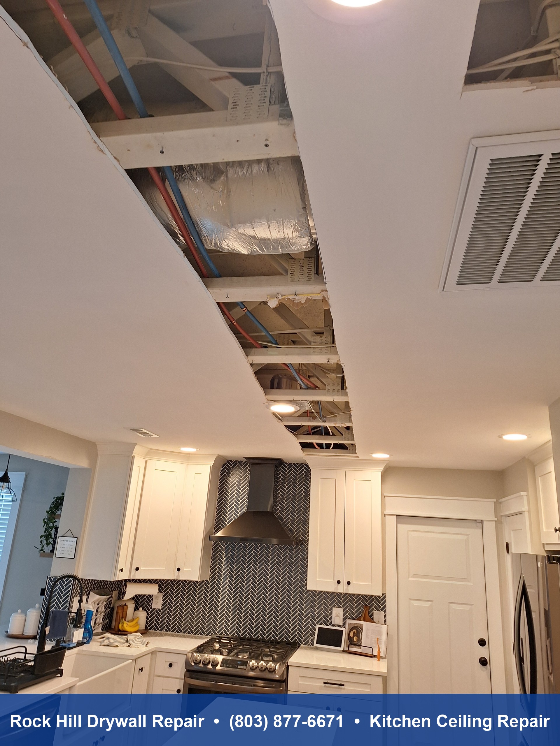 Kitchen ceiling drywall repair with exposed joists and plumbing before restoration in Rock Hill SC
